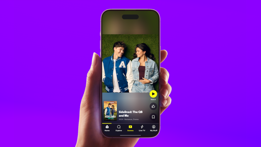 A hand holding an iPhone showing the Tubi Scenes feature